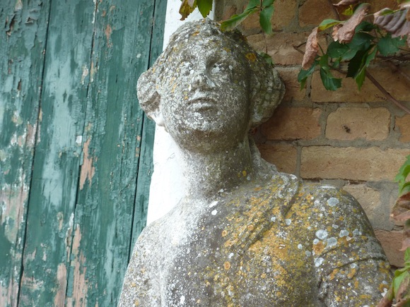 statue against old door in Umbria